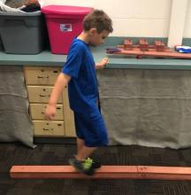 child walking on a balance board
